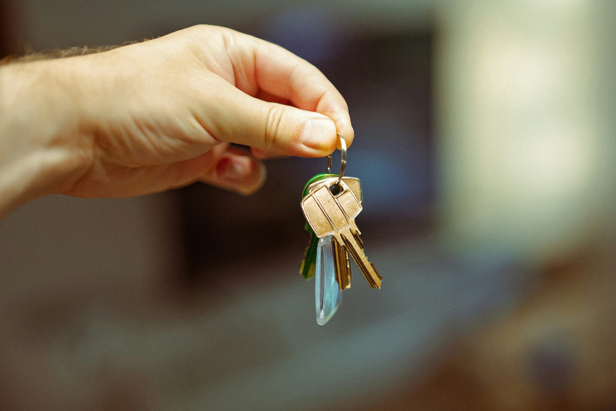 Hand holding house keys, representing rental property investment in central Maryland